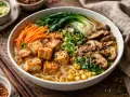 Un bol de ramen veggie appétissant avec des cubes de tofu croustillants, des champignons, du bok choy, des carottes et du maïs.