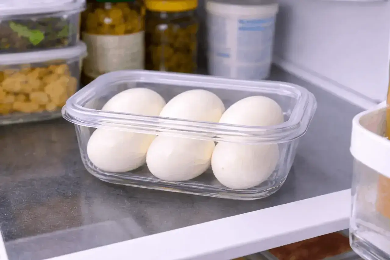 Trois &oelig;ufs durs dans une bo&icirc;te transparente, pr&ecirc;ts pour la conservation au r&eacute;frig&eacute;rateur. Une astuce simple pour la conservation des &oelig;ufs durs.
